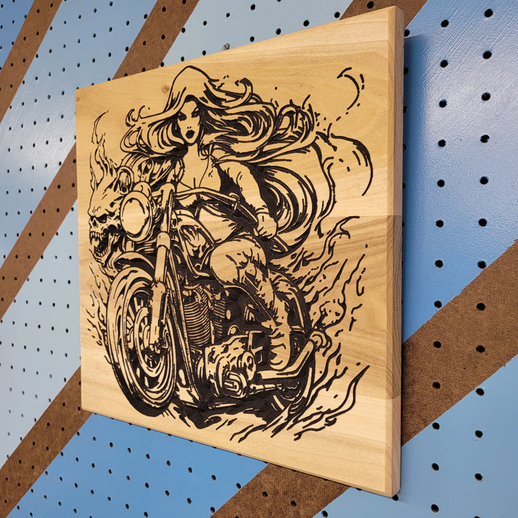 Angled shot of a Relief carved hardwood "Demoness" sign featuring a biker chick on a motorcycle with a skull design.