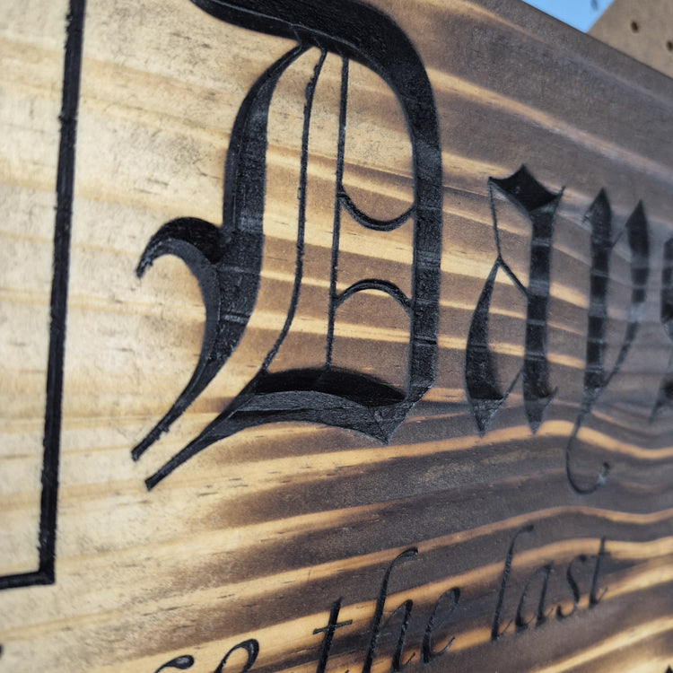 A tight close-up shot focusing on the carved numbers and text, highlighting the incredibly crisp CNC carving lines and the precise hand-painted black details filling the background cuts.