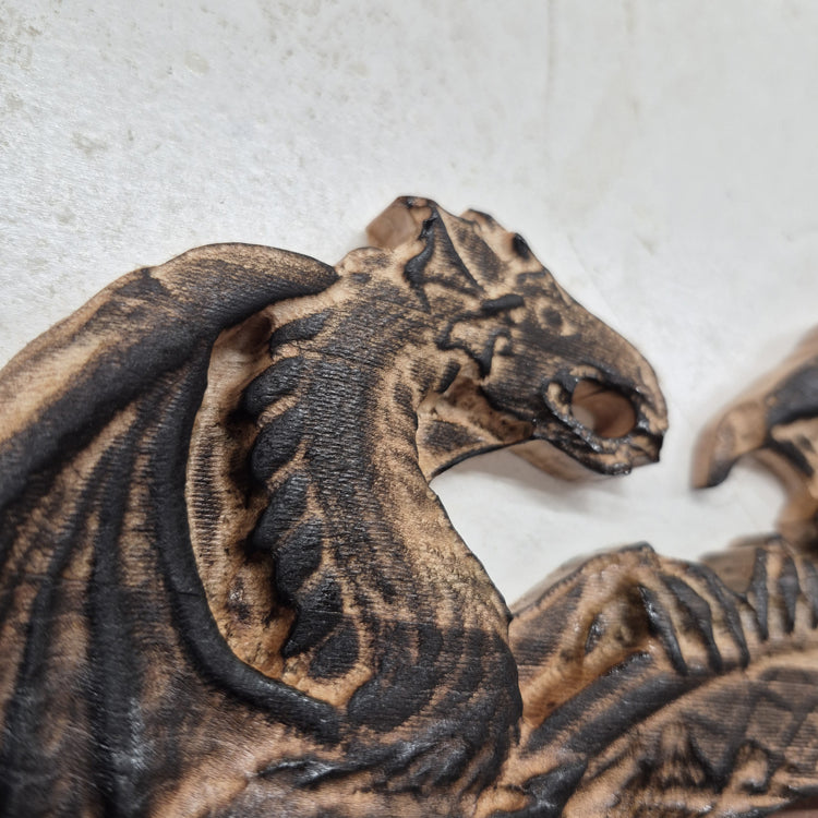 A tight close-up shot focusing on the left 3D carved dragon's head and detailed neck scales. It showcases the incredible depth of the CNC machining, the rich wood grain, and the precise accents.