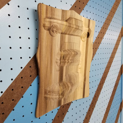 Handcrafted 3-view custom automotive wood carving displayed in a workshop studio.