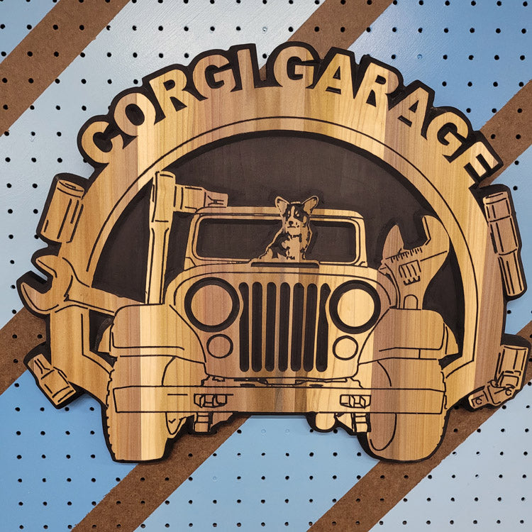 Custom CNC-carved wooden sign featuring a dog in a vintage off-road vehicle illustration and 'Corgi Garage' text, handcrafted and finished by Whiskey River Craftworks.