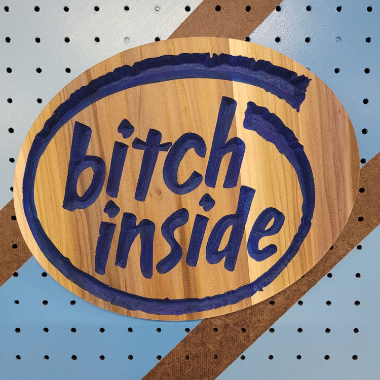 Handcrafted relief-carved hardwood sign featuring a design inspired by the Intel logo, with the text "Bitch Inside."