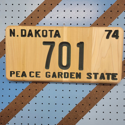 Handcrafted relief-carved hardwood sign designed to look like a classic license plate, fully customizable so you can choose your own state, year, and 7-character text.