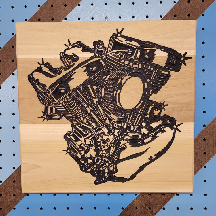 Custom hardwood V-Twin engine motorcycle sign with carved shop art relief design on a blue pegboard.