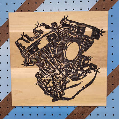 Custom hardwood V-Twin engine motorcycle sign with carved shop art relief design on a blue pegboard.