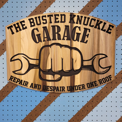 Relief carved hardwood sign featuring the text: "The Busted Knuckle Garage: Repair and Despair Under One Roof."