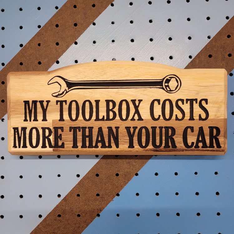 Custom hardwood novelty garage sign with carved wrench graphic and My Toolbox Costs More Than Your Car text.