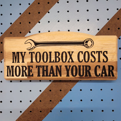 Custom hardwood novelty garage sign with carved wrench graphic and My Toolbox Costs More Than Your Car text.