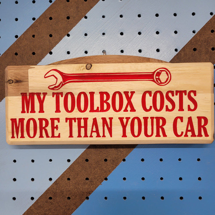 Custom hardwood novelty garage sign with carved wrench graphic and My Toolbox Costs More Than Your Car text.