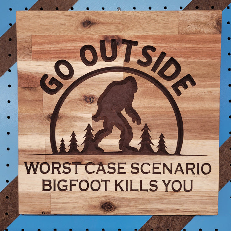 Handcrafted relief-carved hardwood sign featuring a Bigfoot silhouette and the text "Go Outside, Worst Case Scenario Bigfoot Kills You."