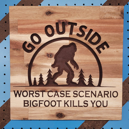 Handcrafted relief-carved hardwood sign featuring a Bigfoot silhouette and the text "Go Outside, Worst Case Scenario Bigfoot Kills You."