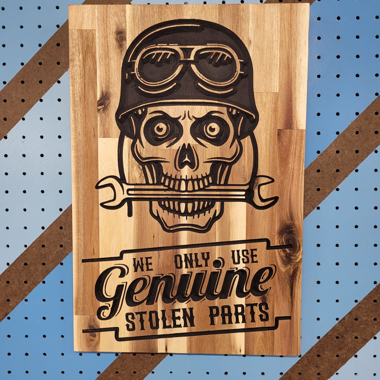 Custom hardwood garage sign with relief carved skull wearing a biker helmet and We Only Use Genuine Stolen Parts text