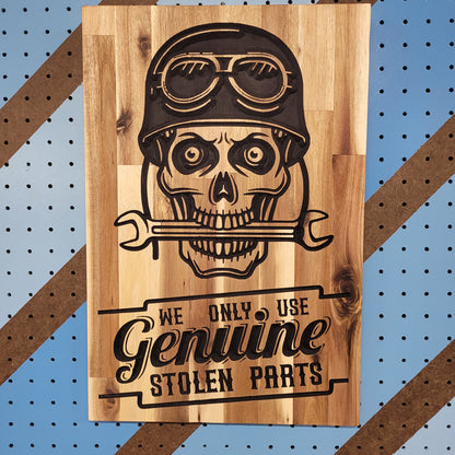 Custom hardwood garage sign with relief carved skull wearing a biker helmet and We Only Use Genuine Stolen Parts text