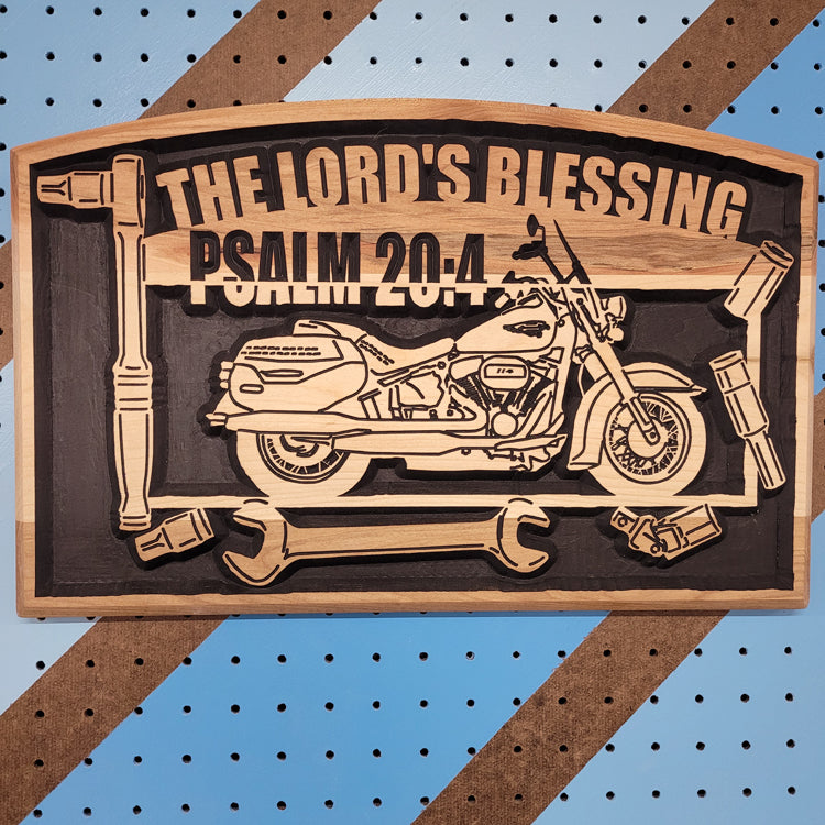 Custom CNC-carved wooden plaque featuring a motorcycle silhouette, assorted mechanical tools, and the text 'The Lord's Blessing Psalm 20:4'.