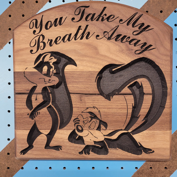 Handcrafted relief-carved hardwood sign featuring a Pepe Le Pew and Penelope Pussycat inspired design with the text "You Take My Breath Away."