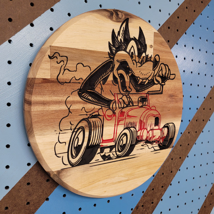 Angled shot of a Handcrafted relief-carved hardwood "Bad Wolf" sign, featuring a stylized cartoon wolf driving a classic hot rod.