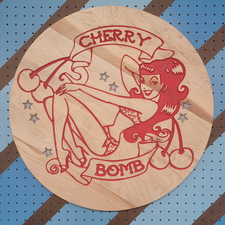 Handcrafted relief-carved hardwood sign featuring a retro "Cherry Bomb" pinup design.