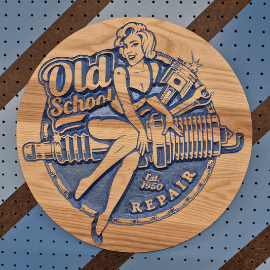 Relief carved hardwood sign with a retro pinup woman holding a wrench on a spark plug design with Old School Repair text.