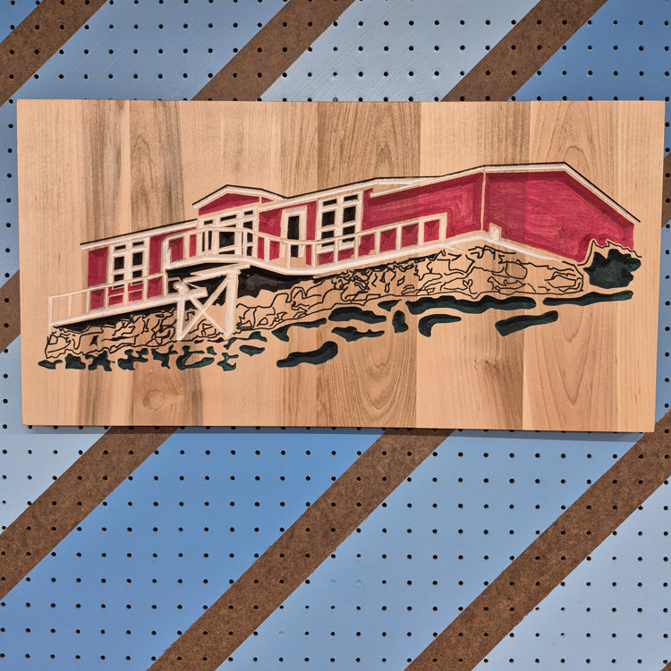 Custom CNC-carved wooden wall art featuring a layered landscape design of a red cabin, handcrafted and finished by Whiskey River Craftworks.
