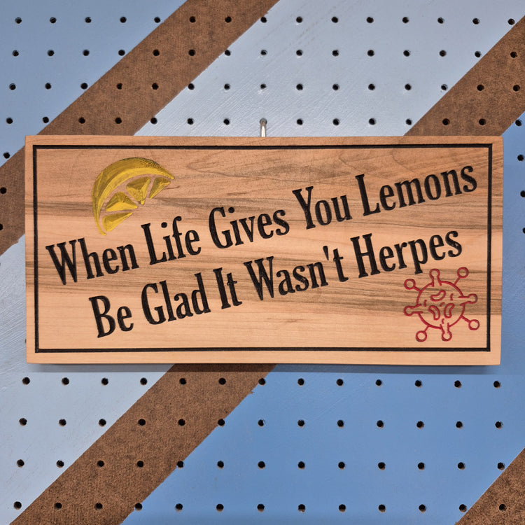 Relief carved hardwood sign featuring a lemon illustration, virus graphic, and When Life Gives You Lemons Be Glad It Wasn't Herpes text.