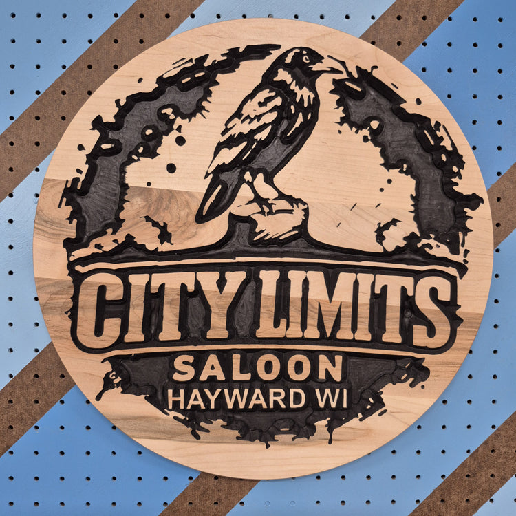 Custom CNC-carved wooden sign for 'City Limits Saloon, Hayward WI,' featuring a bird illustration, handcrafted and finished by Whiskey River Craftworks.