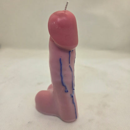 Handcrafted manhood-shaped novelty candle with a lifelike finish on a white background.