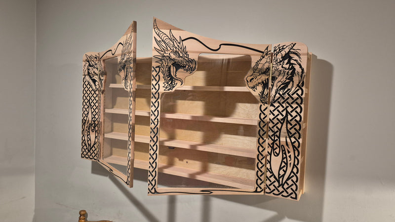 Custom CNC-carved wooden wall-mounted display case featuring intricate dragon and Celtic knotwork designs, handcrafted and finished by Whiskey River Craftworks.