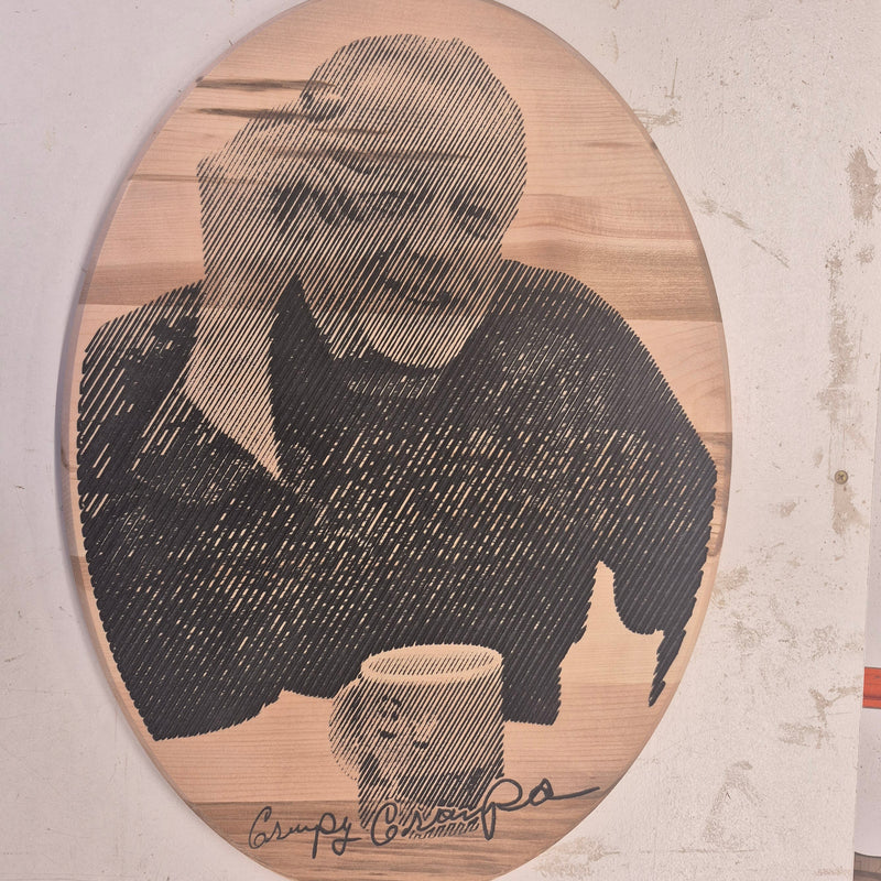 CNC-engraved wooden portrait of a man with a coffee mug, featuring newspaper-style halftone carving, hand-finished by Whiskey River Craftworks.