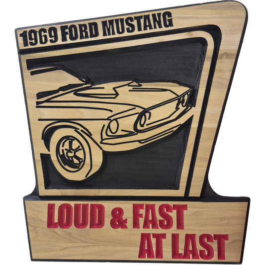 Handcrafted relief-carved hardwood sign featuring a 1969 Ford Mustang and the text "LOUD & FAST AT LAST," fully customizable to showcase your favorite vehicle and personal messaging.