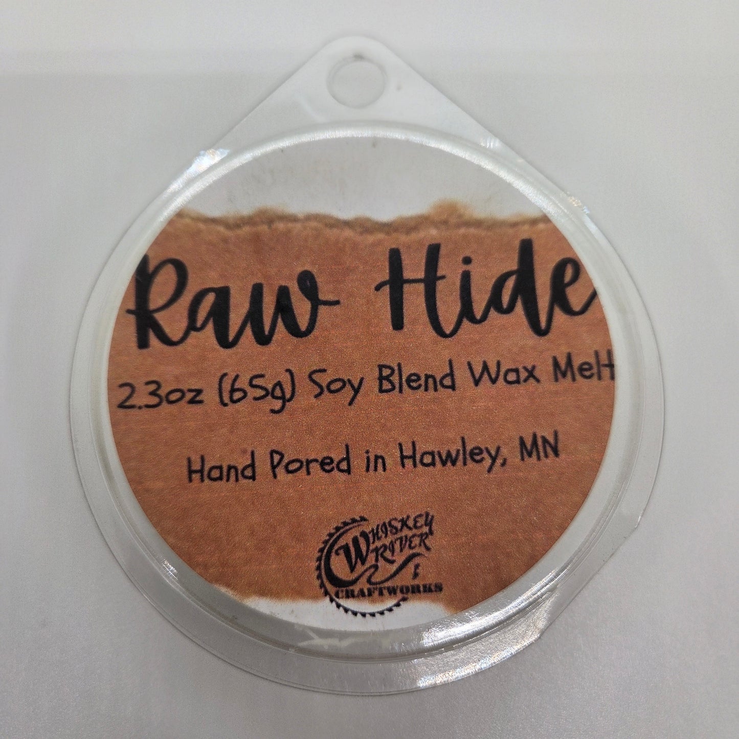 Wax Melts variant in Raw Hide featuring a distressed, brown leather-style custom fragrance label on a clear clamshell pack