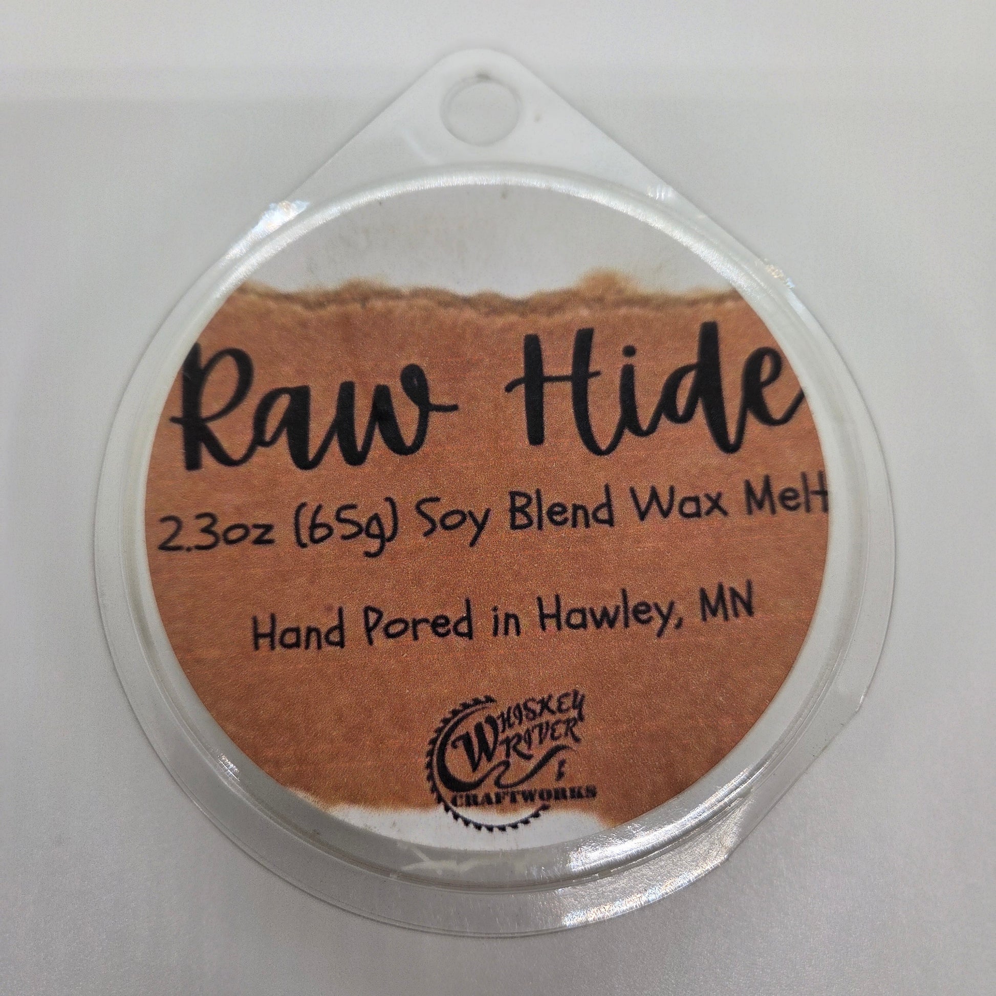 Wax Melts variant in Raw Hide featuring a distressed, brown leather-style custom fragrance label on a clear clamshell pack