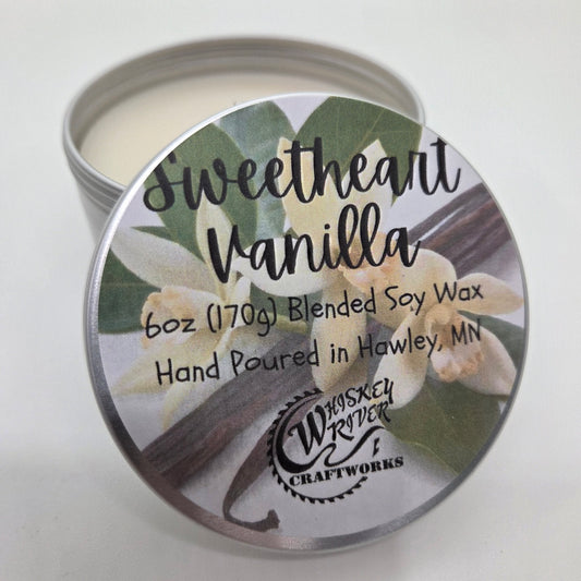Candle tin labeled 'Sweetheart Vanilla' with floral design on a white background
