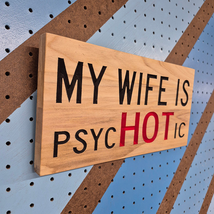 Close-up of the clean finish and natural grain on a 12x6 wooden relationship humor sign.