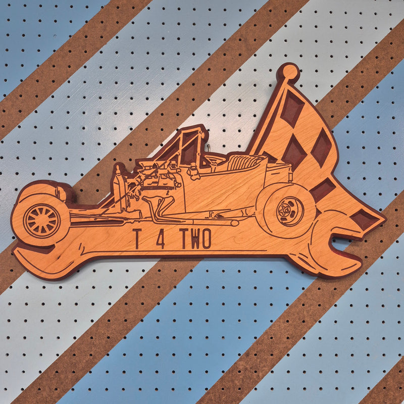 Custom CNC-carved wooden sign shaped like a wrench, featuring a vintage race car silhouette, checkered racing flags, and the text 'T 4 TWO'.