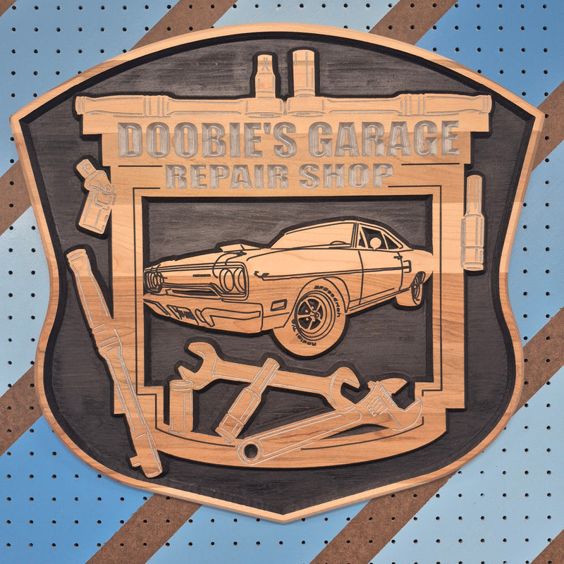 Custom CNC-carved wooden plaque featuring a muscle car silhouette, wrenches, and the text 'Doobie's Garage Repair Shop'
