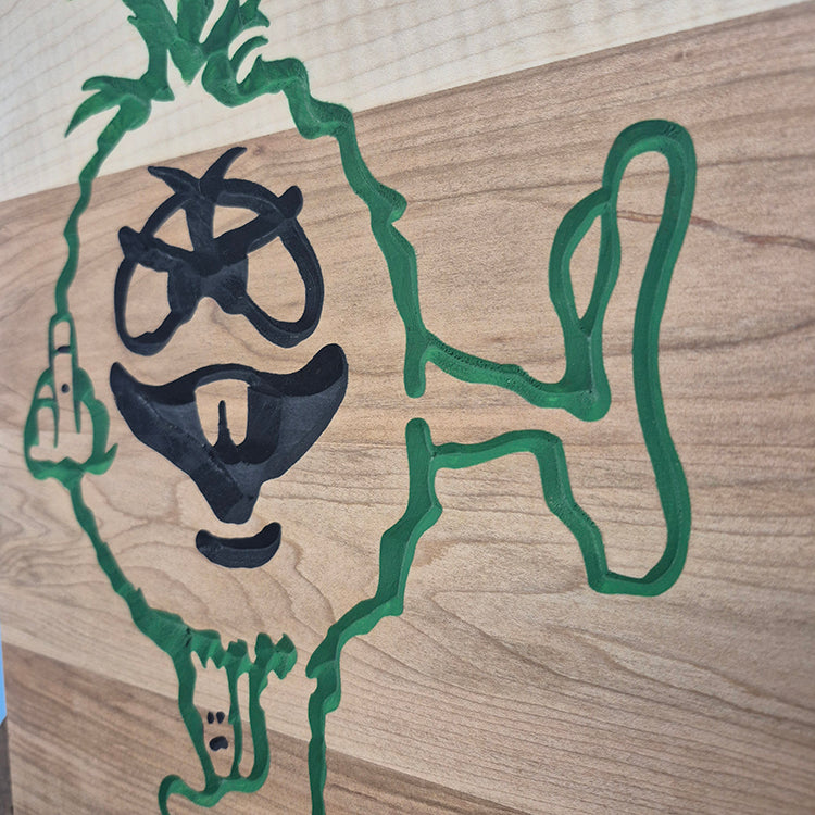 Close-up of the carved details and natural wood grain on a novelty middle finger shop sign.