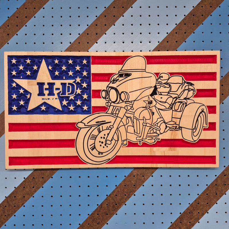 Custom CNC-cut wooden wall art featuring a motorcycle silhouette layered over an American flag, handcrafted by Whiskey River Craftworks.