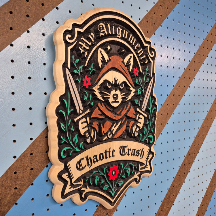 Angled view of the "Chaotic Trash" carved wood plaque, showcasing the deep CNC-machined relief texture, clean lettering, and premium hardwood grain patterns.