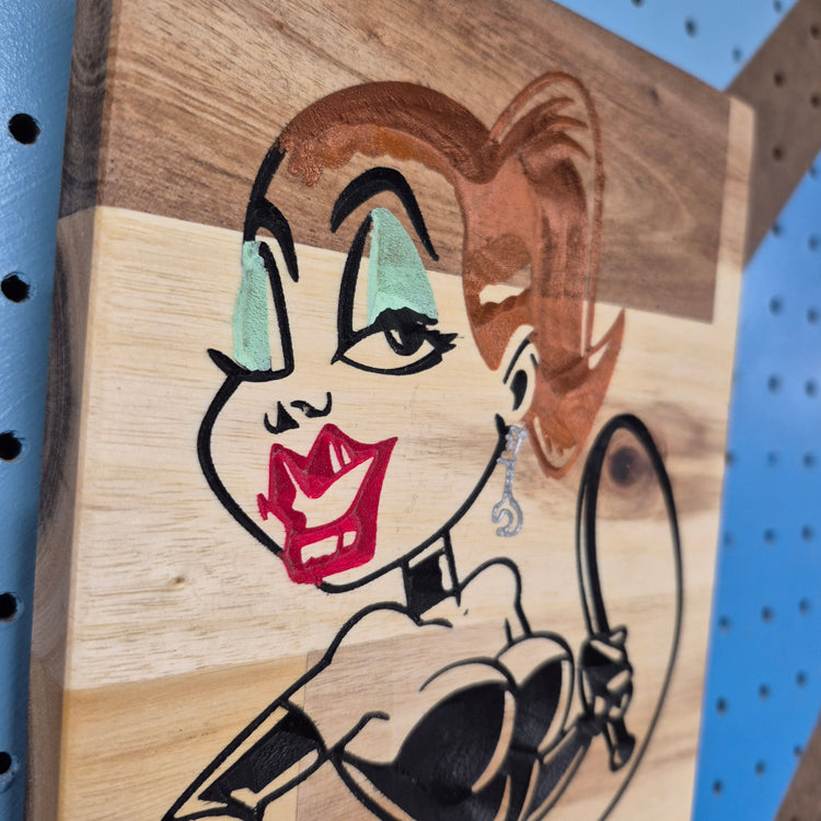 Close-up detail of the smooth finish and natural grain on a hand-painted wooden novelty sign.