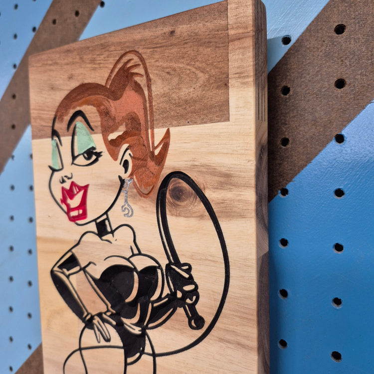 Close-up detail of the smooth finish and natural grain on a hand-painted wooden novelty sign.