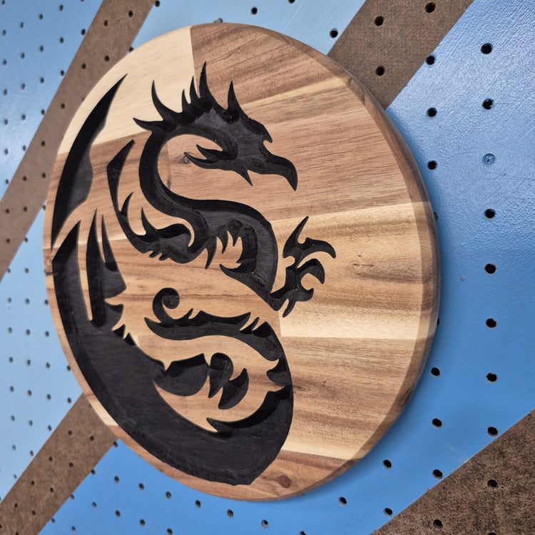 A perspective view from the opposite angle of the custom carved dragon sign, showcasing the clean, smooth outer circle edge and the professional finish of the premium hardwood.