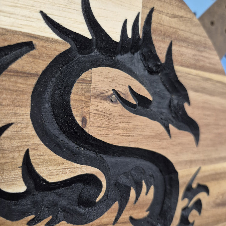 A tight close-up shot focusing on the top section of the dragon's head, showcasing the incredibly crisp CNC carving lines, the rich natural wood grain, and the precise hand-painted black details filling the background cuts.