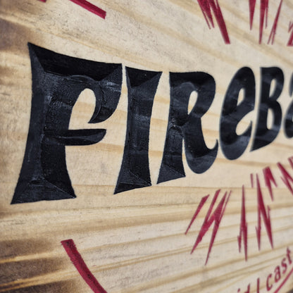 A tight close-up shot focusing on the bold text and the outer blast lines of the flame carving, highlighting the incredibly crisp CNC machining and the precise hand-painted black and red details filling the background cuts.