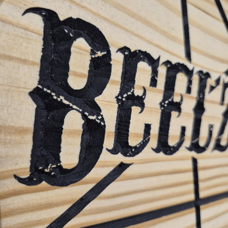 A tight close-up shot focusing on the carved text and sharp lines of the pentagram, highlighting the incredibly crisp CNC machining and precise hand-painted black details filling the background cuts.
