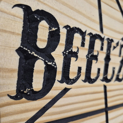 A tight close-up shot focusing on the carved text and sharp lines of the pentagram, highlighting the incredibly crisp CNC machining and precise hand-painted black details filling the background cuts.