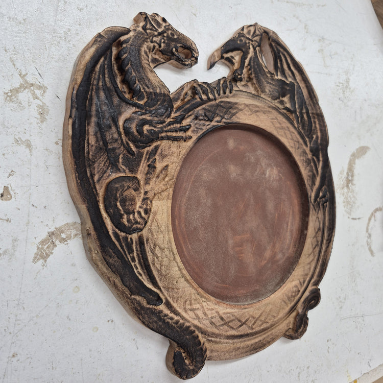 A perspective view from the opposite angle of the carved dragon dice tray, showcasing the smooth outer rim and the clean contrast of the hand-painted black details.