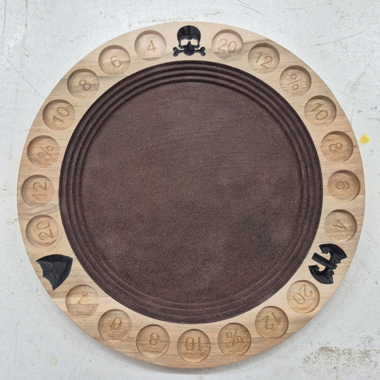 A top-down view of a circular 10.5-inch solid hardwood dice rolling tray featuring a carved border with a gladiator helmet, battle axe, and shield motifs, hand-painted dark brown accents, and a brown flocked velvet center.