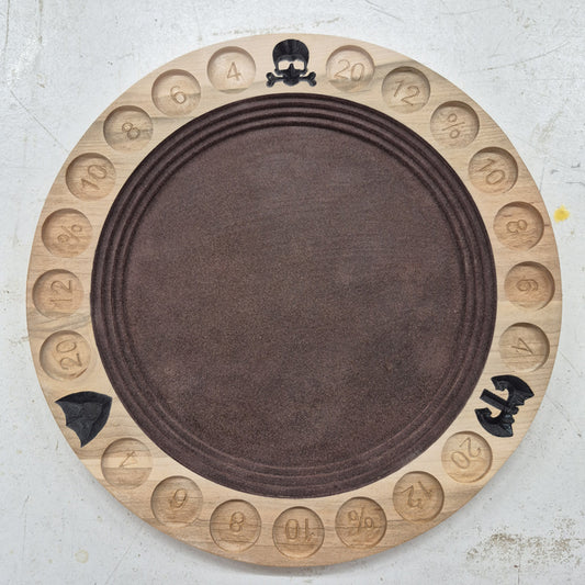 A top-down view of a circular 10.5-inch solid hardwood dice rolling tray featuring a carved border with a gladiator helmet, battle axe, and shield motifs, hand-painted dark brown accents, and a brown flocked velvet center.
