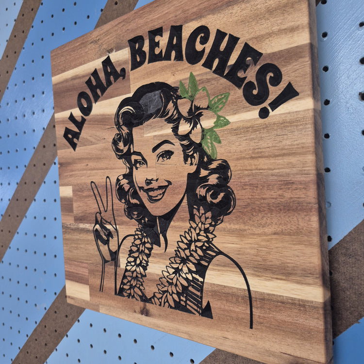 Angled Shot showing CNC Carved plaque saying Aloha, Beaches! with a 50's Pinup showing a Peace sign