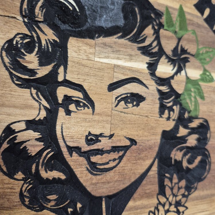 Close up shot showing CNC Carved plaque saying Aloha, Beaches! with a 50's Pinup showing a Peace sign